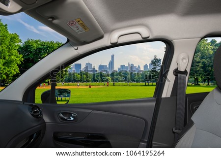 Looking through a car window with view of Central Park and a beautiful contrast between skyscrapers and buildings, Manhattan, New York City, USA
