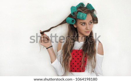 a girl in hair curlers