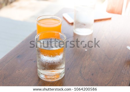 Water in a glass by the sea on a wooden floor nature