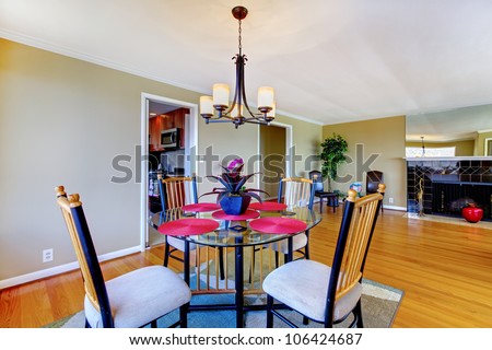 Dining room with round table and fireplace in green and pink.