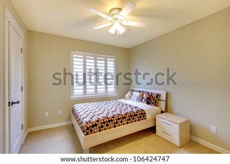 Kids bedroom with minimal design and beige walls.