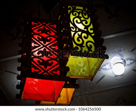 Stylish & colorful hanging lamp with lampshades isolated unique stock photograph