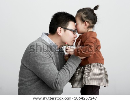 Asian father and daughter, make-up game, studio shot