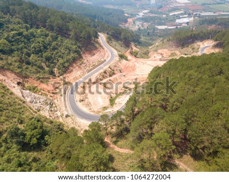 Top view. Aerial view from drone. Royalty high quality free stock image of road in forest. Road in forest is beautiful with many tree, road on pass very winding and curve