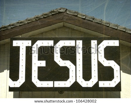   aged and worn vintage photo of  jesus sign
