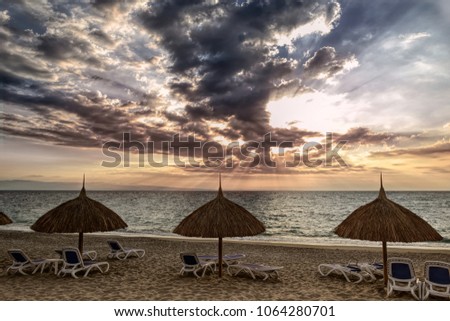 Moody sky sunset, Sunchair Lifeguard tower on caribbean beach, Haiti