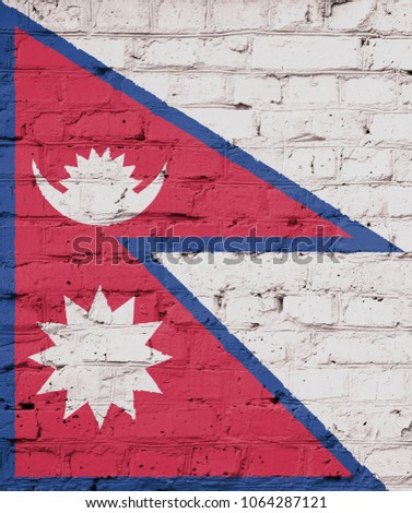 Texture of a flag of Nepal on a brick wall.
