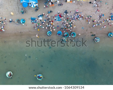 Top view. Aerial view fishing harbour market from drone. Royalty high quality free stock image of market at Mui Ne fishing harbour or fishing village. Fishing harbor is a popular tourist destination