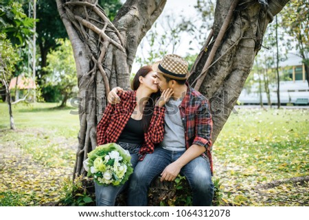 Close-up of a man giving happy woman flowers.A picture of a romantic couple getting.