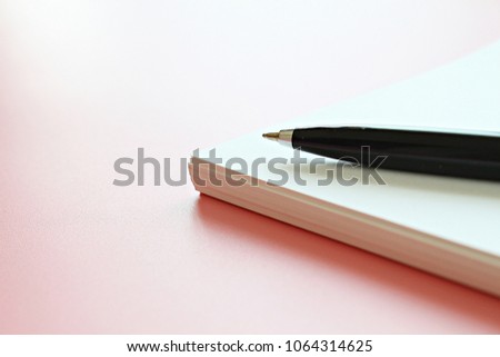 Still life, business, office supplies or education concept : Open notebook paper and pen on pink background with copy space, ready for adding or mock up