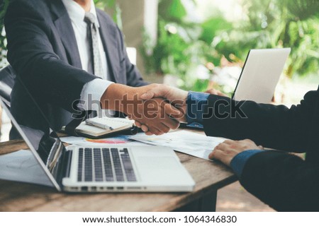 Business man shaking hand after signing contract with cooperator, Team work concept, Dealing complete