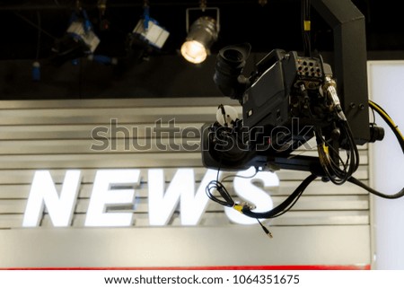 Camera in broadcast  news room.