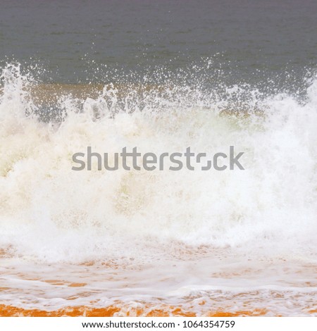 Foam wave, running on the sandy shore.