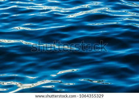 Blurred sea water texture with small waves
