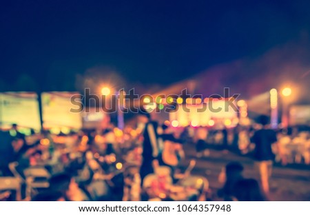 Abstract blurred Outdoor Party on night time with bokeh for background usage . (vintage tone)