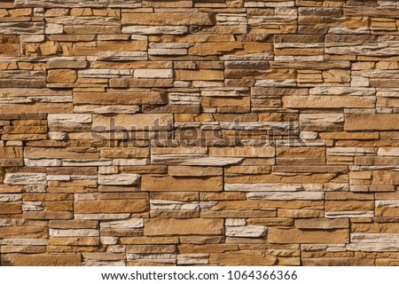 Stone wall of natural stones in different sizes. Royalty-Free Stock Photo #1064366366