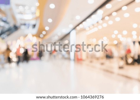 Abstract blur people in modern shopping mall interior defocused background