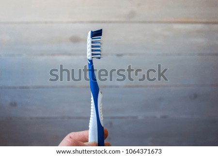 a man hand holding a toothbrush
