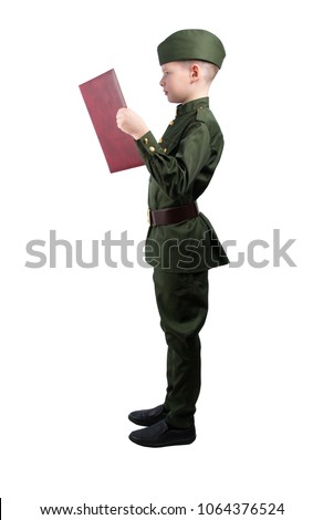 boy in military uniform and a cap, stands sideways, holds a book in his hands and reads the oath, on a white background