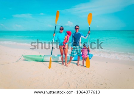 happy family with kids kayaking at beach