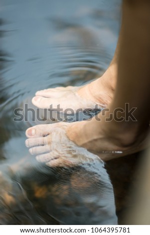 Water flow through foots like spa foot in a waterfall feeling cool in the nature