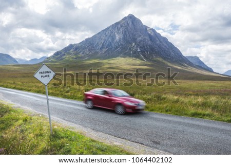 Passing place sign beside empty road, Glen Coe, Scotland