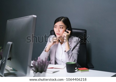 Stress business woman at her working desk and computer.Sad and stress woman at work.