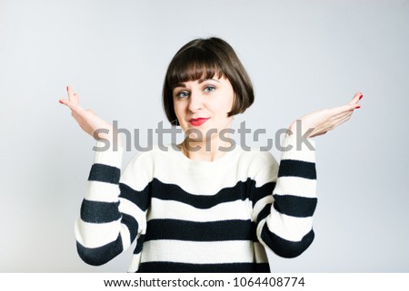 beautiful young woman can not choose, short haircut, studio photo on the background