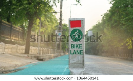 green road and bike lane sign show on street for outdoor activity 
