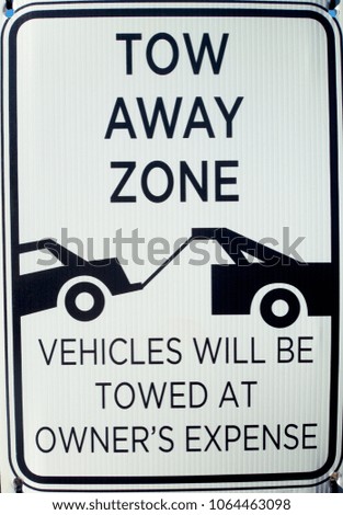Tow away warning sign.