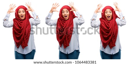 Arab woman wearing hijab happy and surprised cheering expressing wow gesture isolated over white background