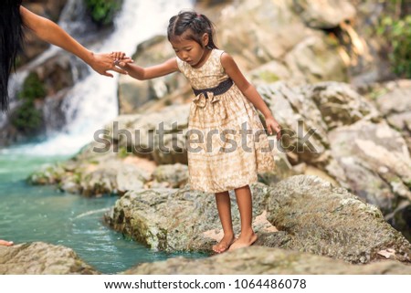 happy mother with her daughter in the tropics near the waterfall. Mothers day.