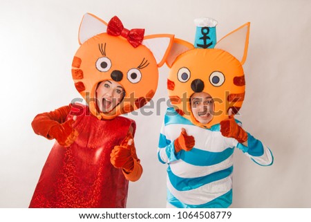 Young girl and guy in the chic costumes of cats