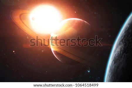 Ringed gas giant in front of glowing Sun. Space science fiction visualization. Elements of this image furnished by NASA