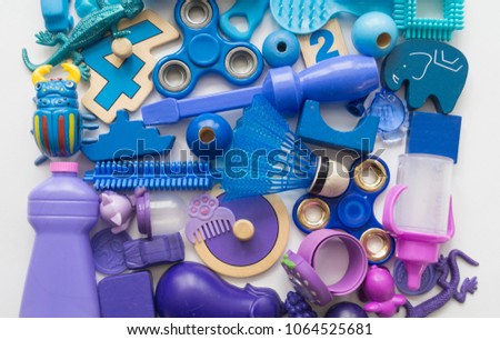 Very many kids toys.White background.  Flat lay. Copy space for text. Preschooler at home or daycare, preschool. Kindergarten educational games. The colors are blue and purple.