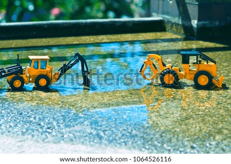 bulldozer lined up on slightly submerged cement in water.