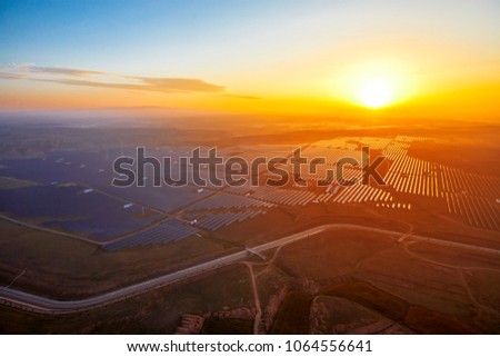 Aerial photo of new energy solar photovoltaic panels at sunrise