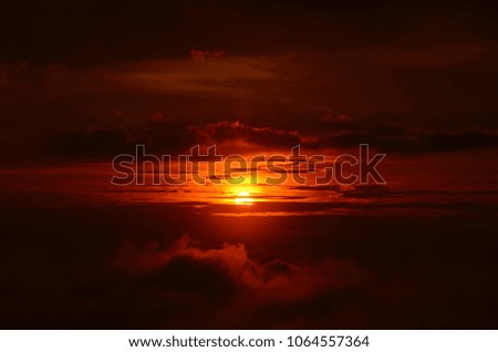 sunrise on top of Jerai Hill, silhouette of trees and clouds. images may contain noise, grain and sun flare or glare.