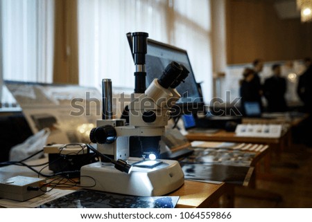 Close up view of microscope lenses platen and slide