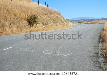 A hand-lettered sign on the roadway cautions motorists driving in the Sierra Nevada Mountains