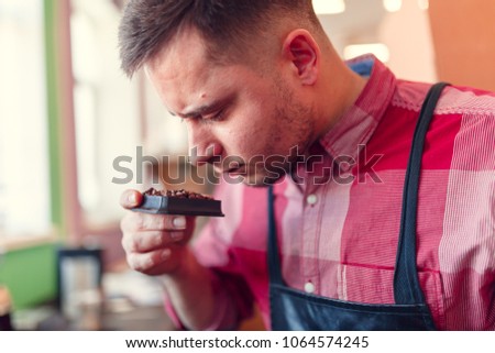 Photo of businessman sniffing coffee beans