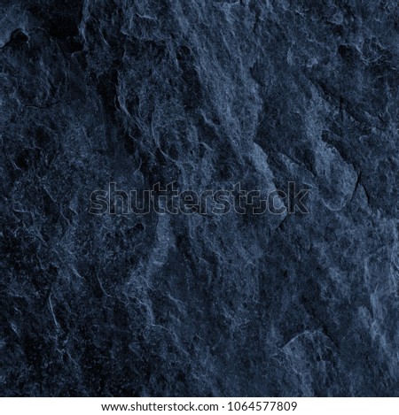 Dark gray slate background or natural black stone texture.