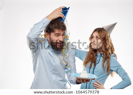  woman adjusting a holiday cap for a man, a birthday                       