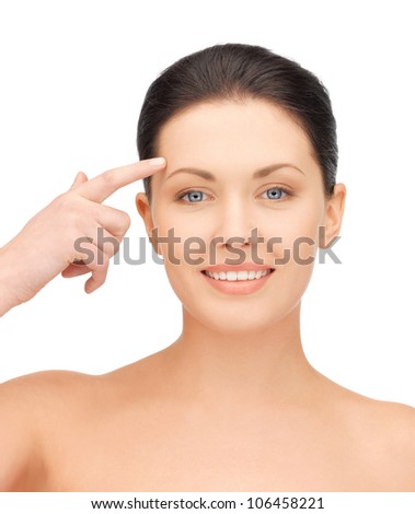 picture of beautiful woman pointing to forehead