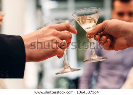 Martini glasses in the hands of celebrating the holiday close-up