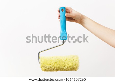 Close up of female hand horizontal holds paint roller for wall painting isolated on white background. Instruments for renovation apartment room. Repair home concept. Copy space for advertisement