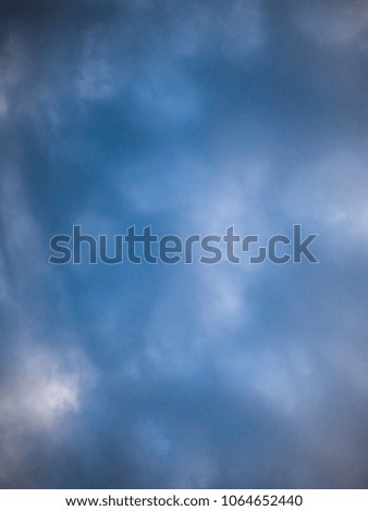 Blurry blue sky with soft clouds