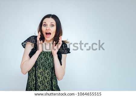 beautiful girl on a white background admires a surprised on a white background