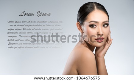 Beauty shot of young pretty asian woman with clear skin ongrey background, for skin ad and cosmetology with copy space for text insertion