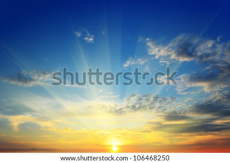 the sun's rays illuminate the sky above the horizon